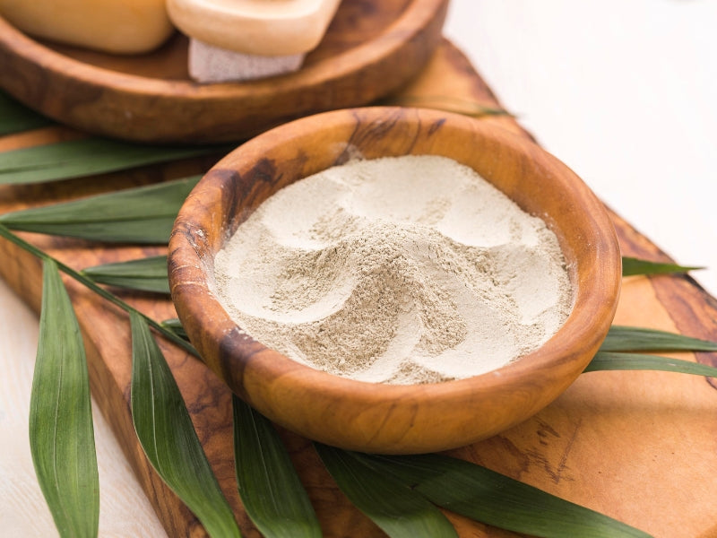 coconut powder in bowl with leaves